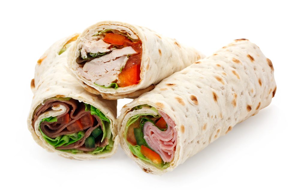 A sliced tortilla wrap a rollup of flatbread with assorted fillings
