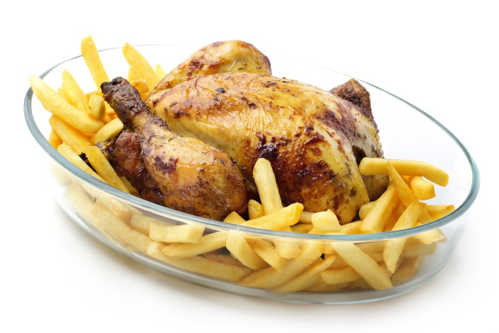 roasted chicken with french fries in oven dish